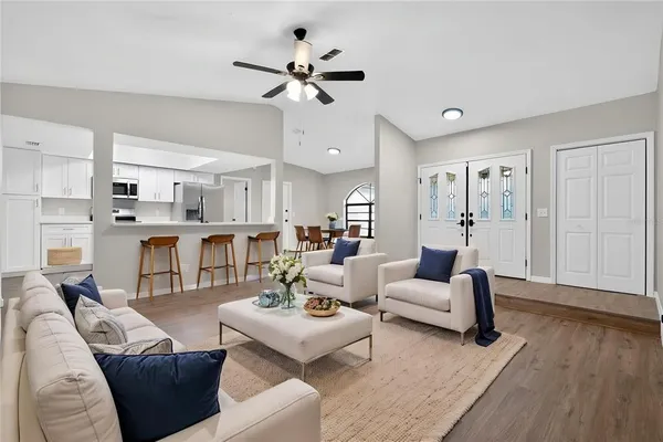 a living room with furniture and kitchen view