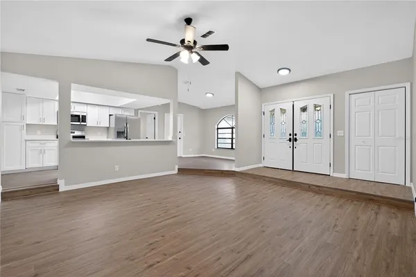 a view of a kitchen with a sink and cabinet with wooden floor
