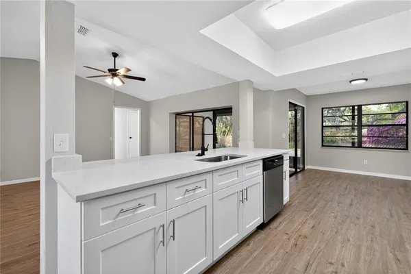 a kitchen with stainless steel appliances a white stove top oven a sink dishwasher and a refrigerator