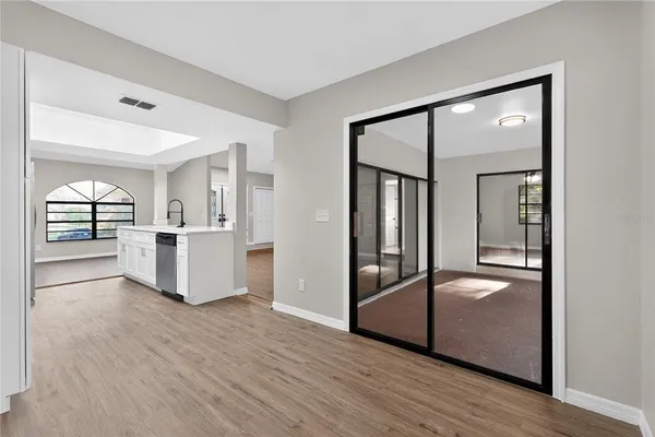 wooden floor in an empty room with a window