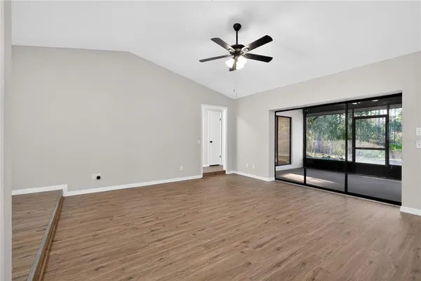 a bedroom with a large bed chandelier and a window