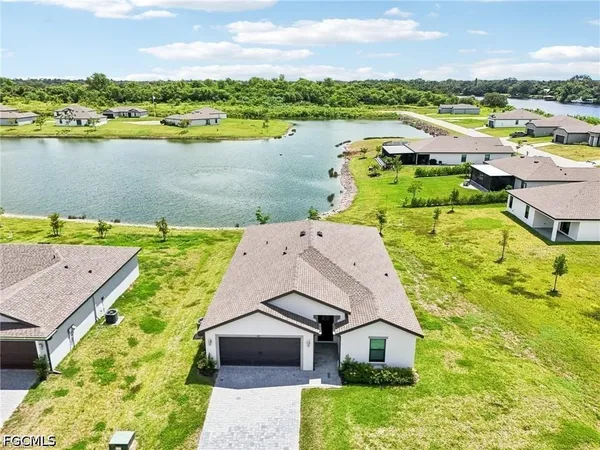 an aerial view of a house with a lake view