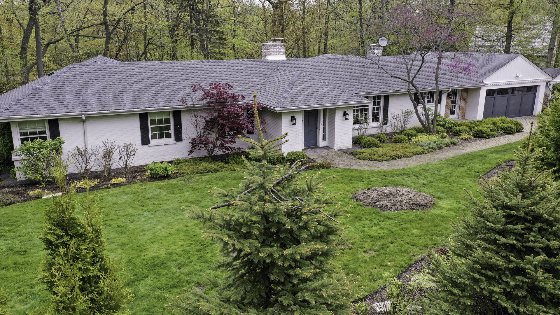 1020 East Westleigh Road Lake Forest, IL 60045 - Photo 1 of 31 a front view of a house with a yard and potted plants