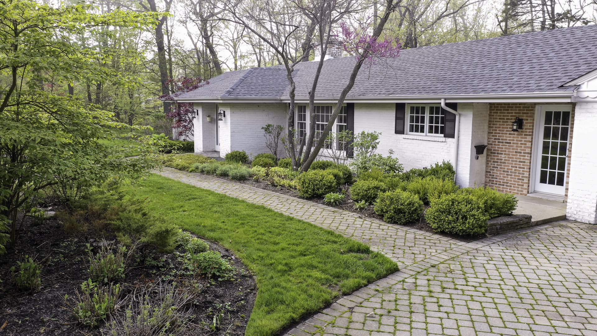 1020 East Westleigh Road Lake Forest, IL 60045 - Photo 2 of 31 a front view of a house with a garden