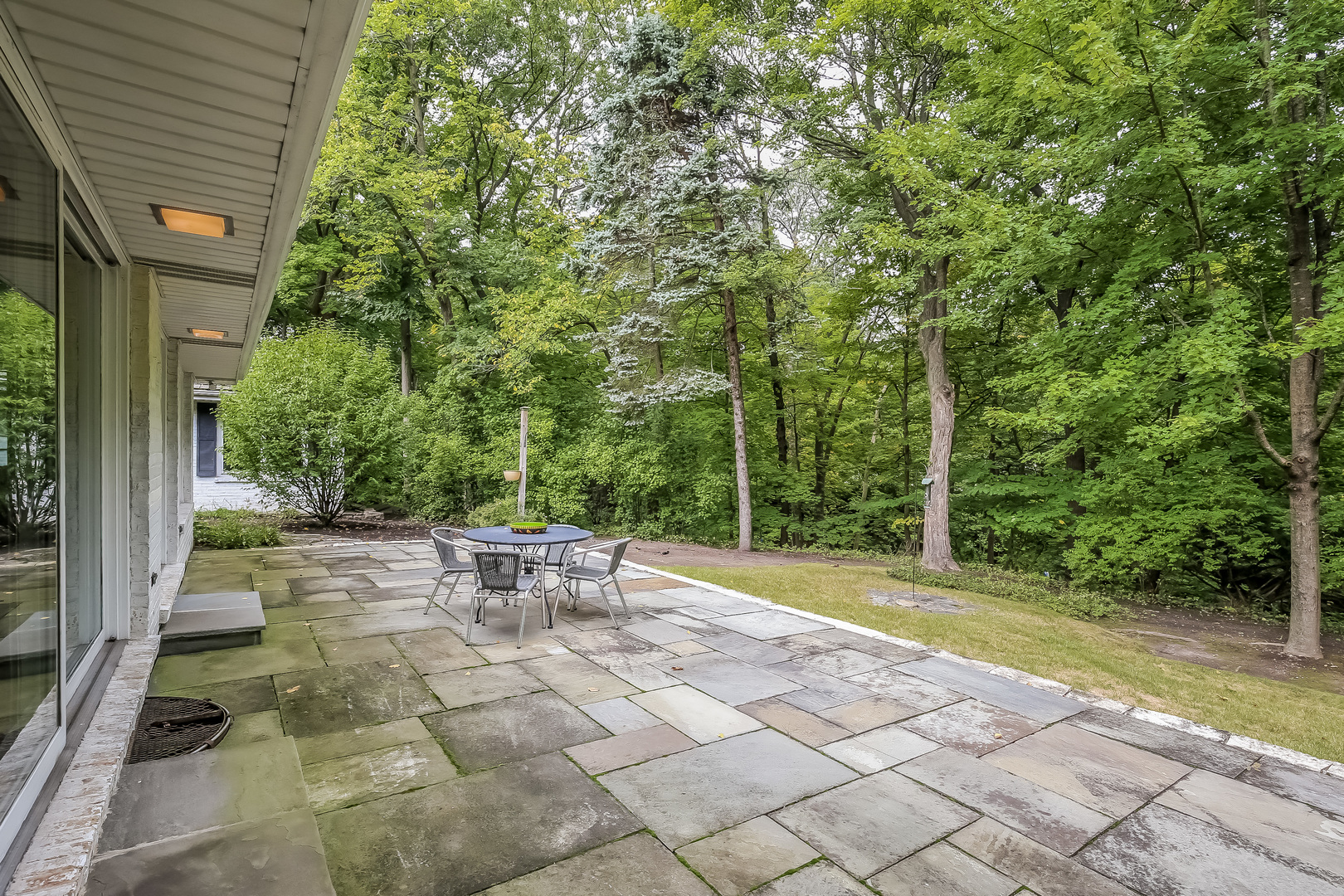 1020 East Westleigh Road Lake Forest, IL 60045 - Photo 25 of 31 a view of backyard with table and chairs and large trees