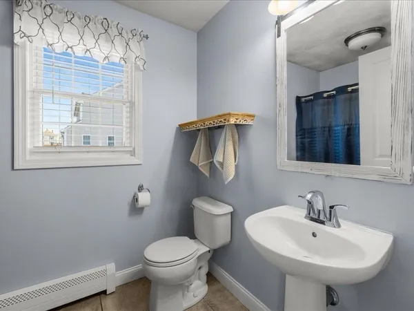 a bathroom with a sink toilet and mirror