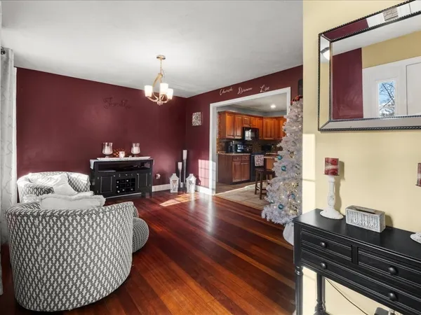 a living room with furniture and a chandelier