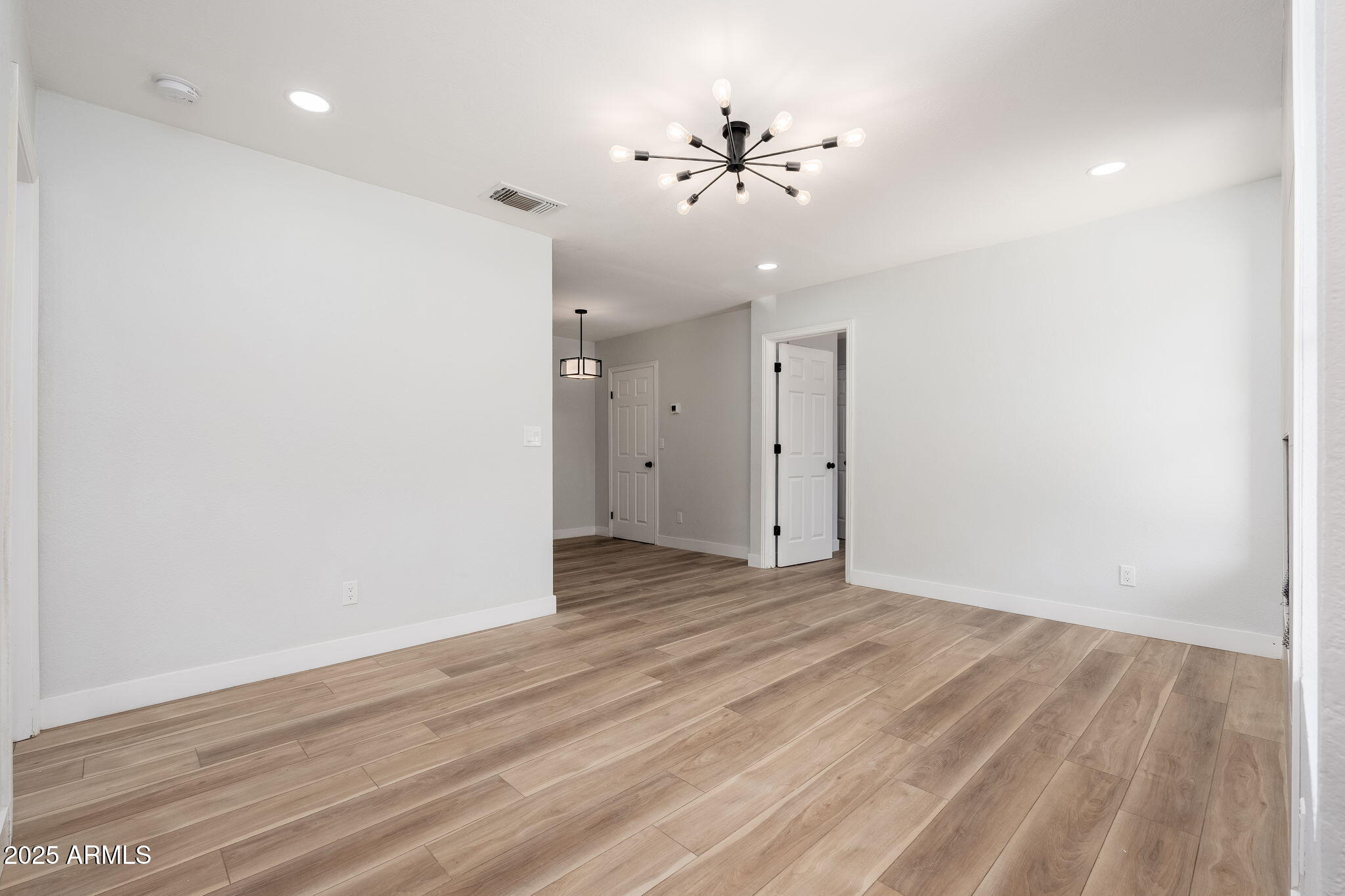 3511 East Baseline Road, Unit 1200 Phoenix, AZ 85042 - Photo 2 of 28 a view of an empty room with wooden floor