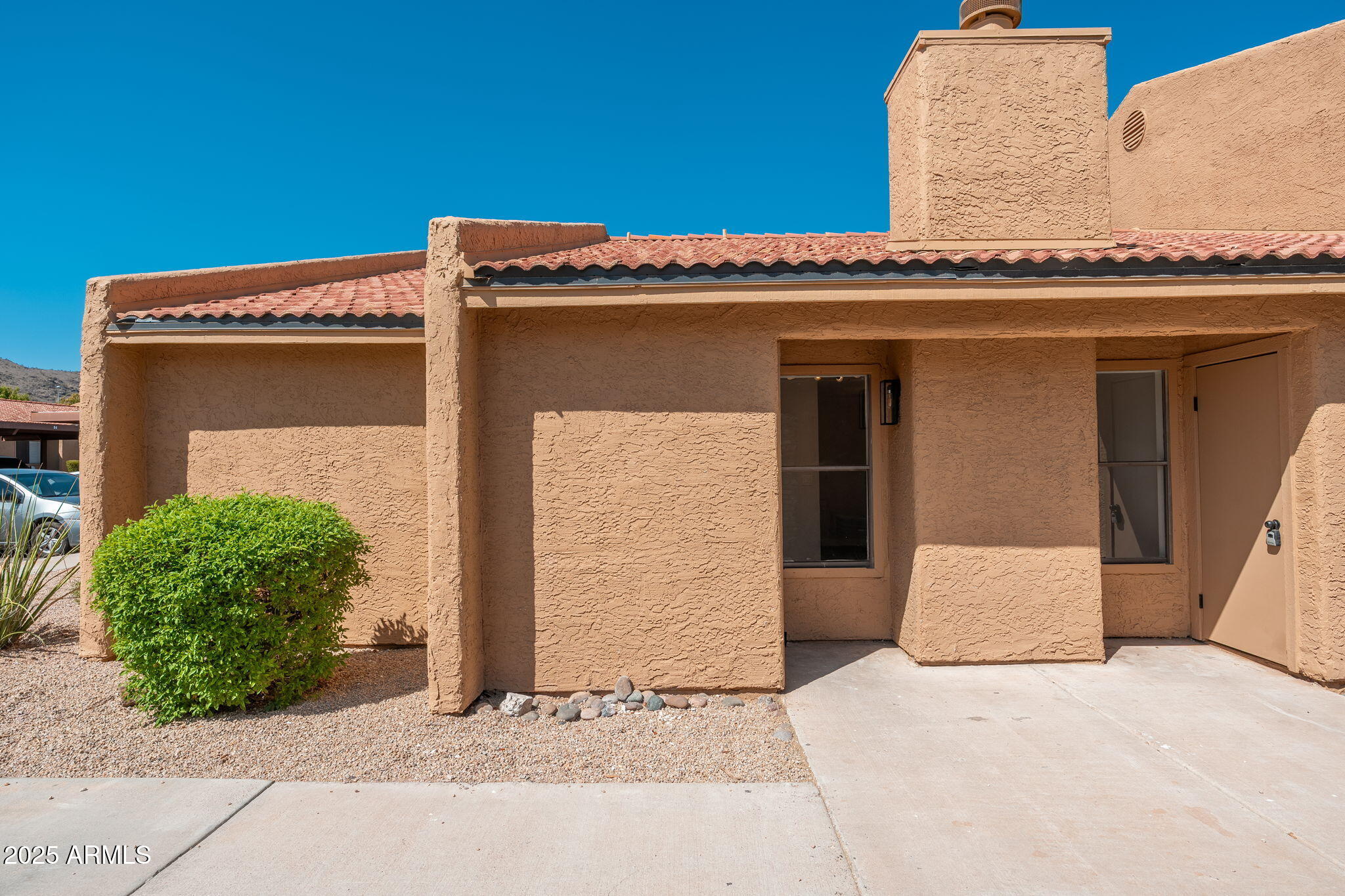 3511 East Baseline Road, Unit 1200 Phoenix, AZ 85042 - Photo 21 of 28 a front view of a house with a garage