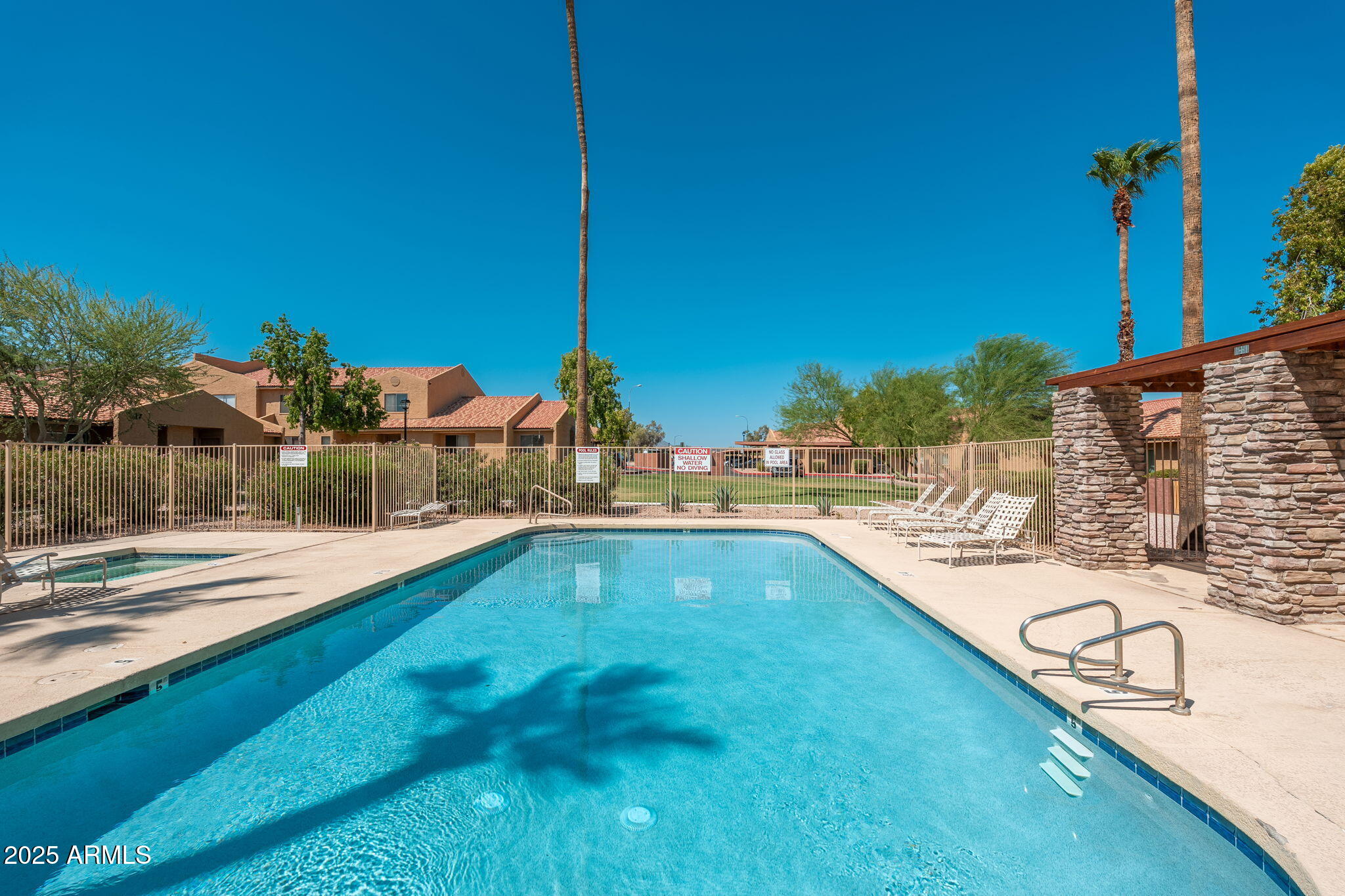 3511 East Baseline Road, Unit 1200 Phoenix, AZ 85042 - Photo 23 of 28 a view of a swimming pool with a lawn chairs