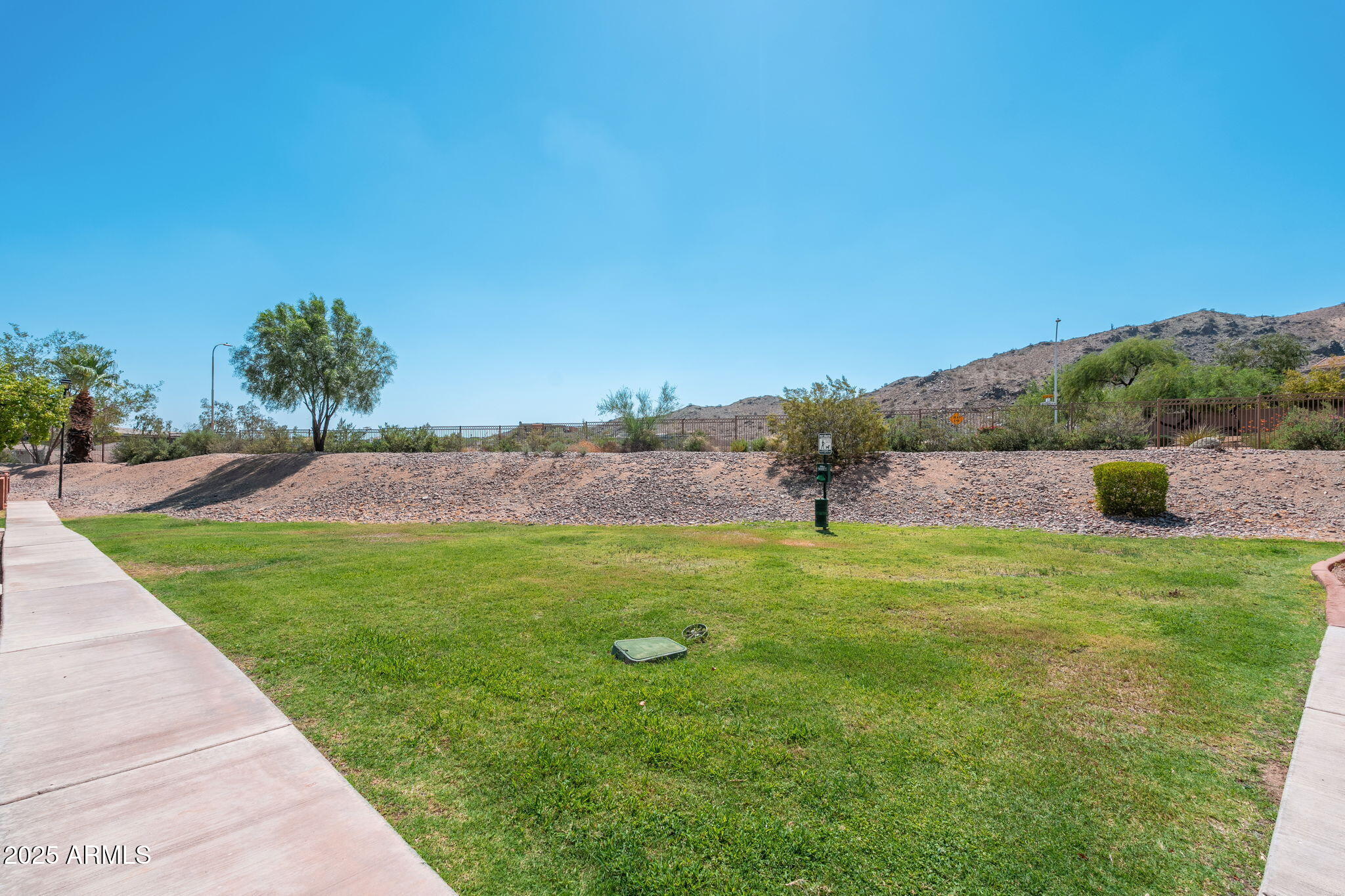 3511 East Baseline Road, Unit 1200 Phoenix, AZ 85042 - Photo 25 of 28 a grassy field with lots of trees in the background