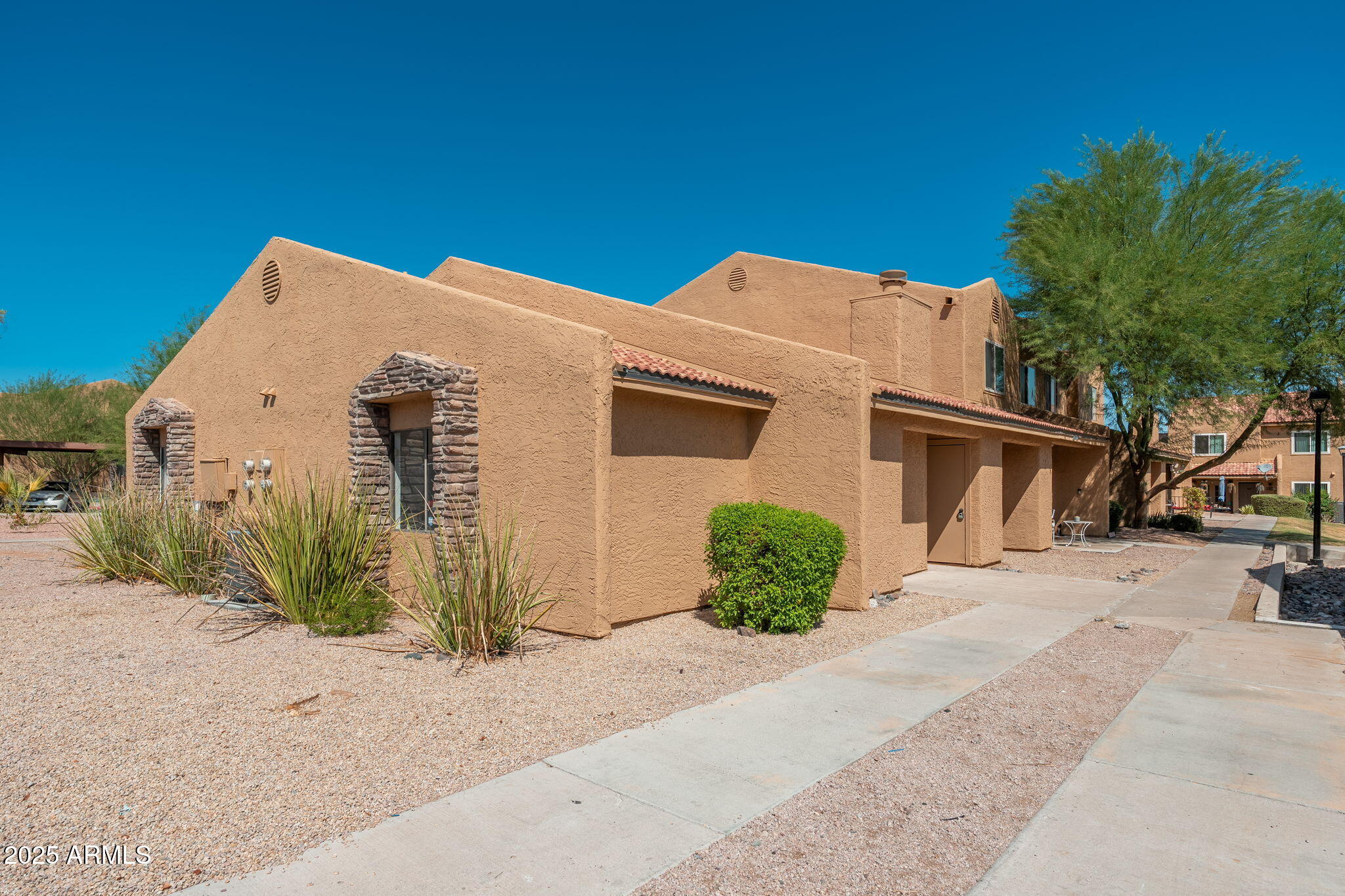 3511 East Baseline Road, Unit 1200 Phoenix, AZ 85042 - Photo 3 of 28 a front view of a house with a yard