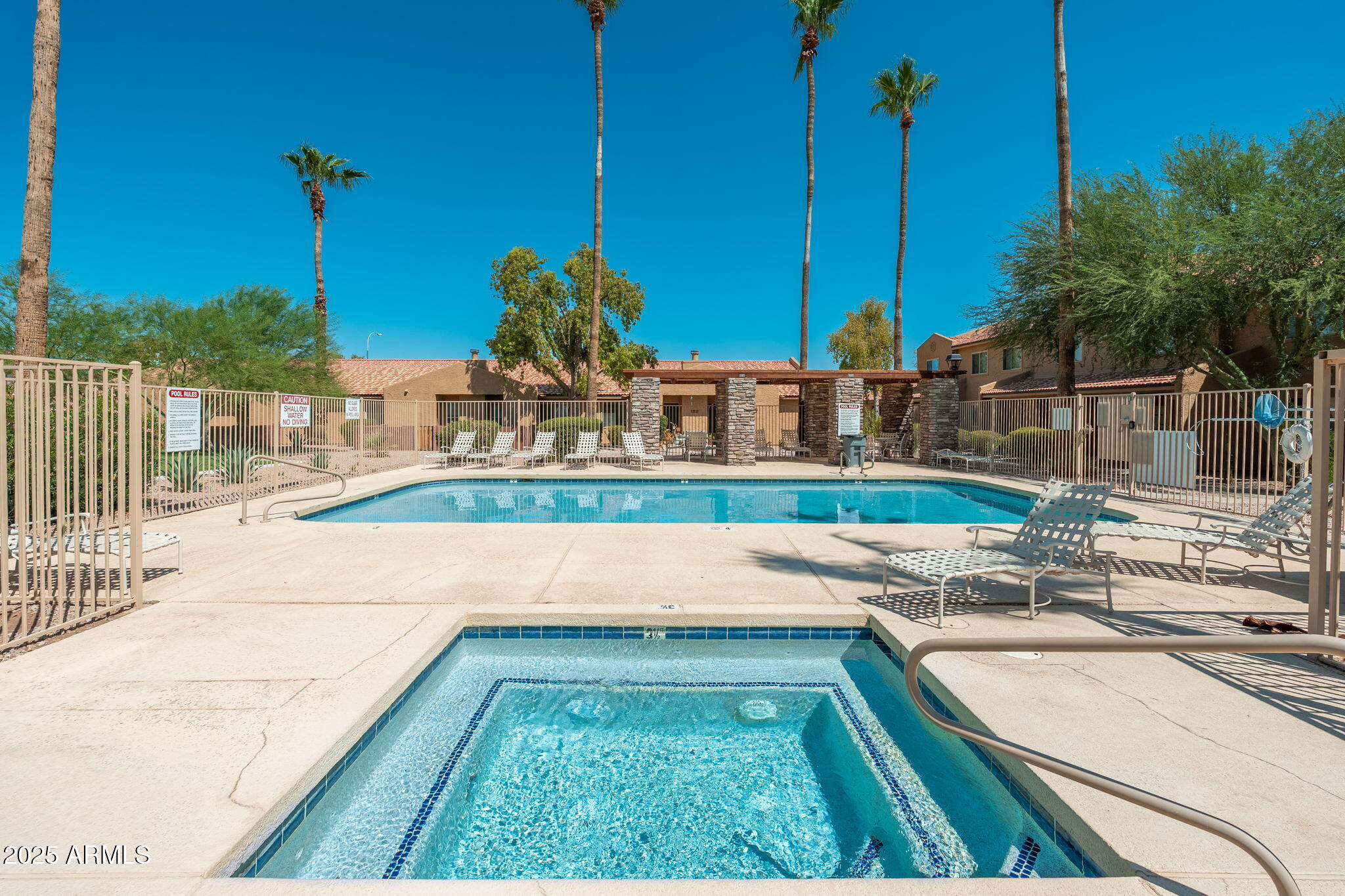 3511 East Baseline Road, Unit 1200 Phoenix, AZ 85042 - Photo 4 of 28 a view of a swimming pool with a chair