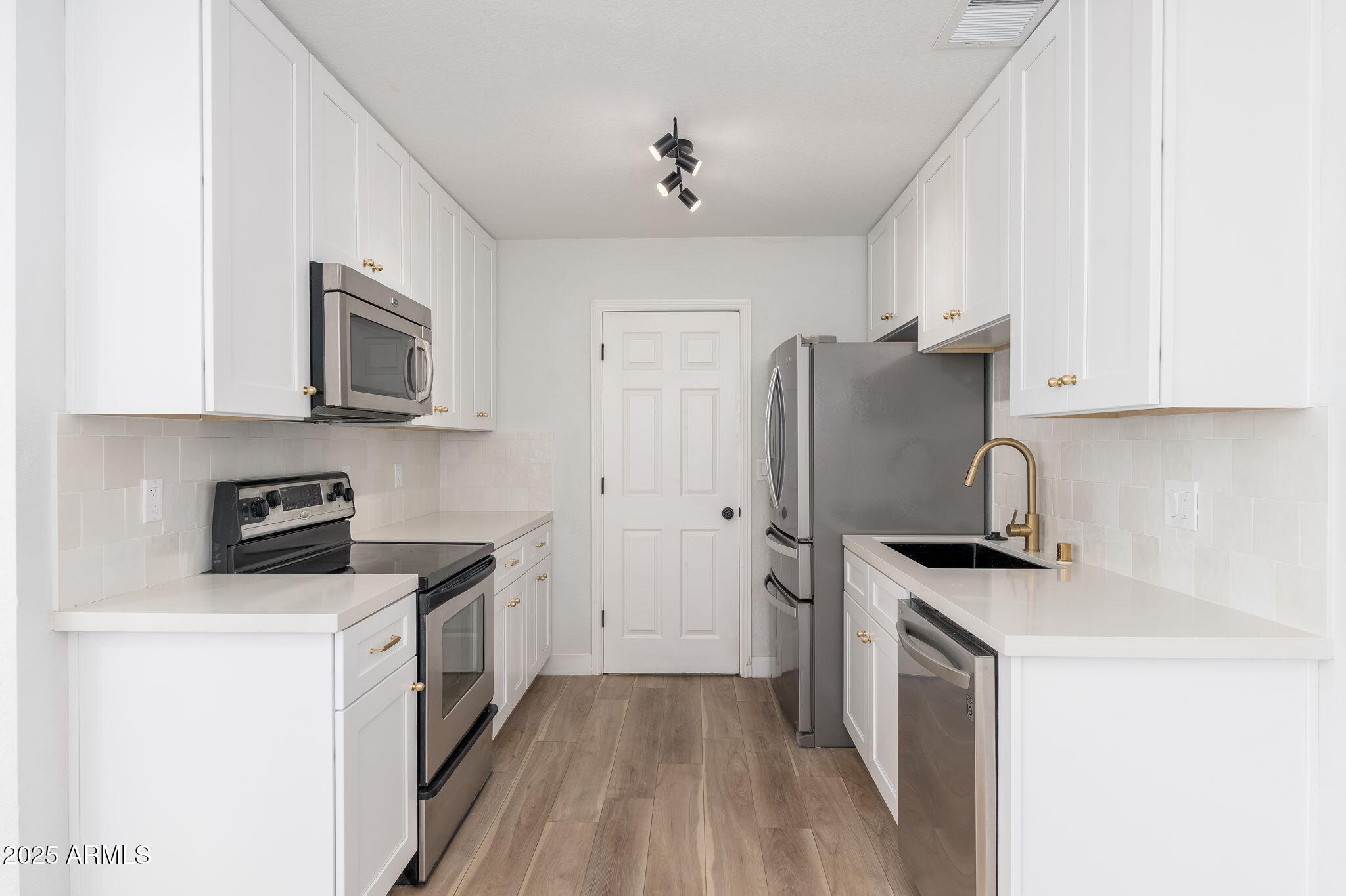 3511 East Baseline Road, Unit 1200 Phoenix, AZ 85042 - Photo 6 of 28 a kitchen with a stove a refrigerator and a sink