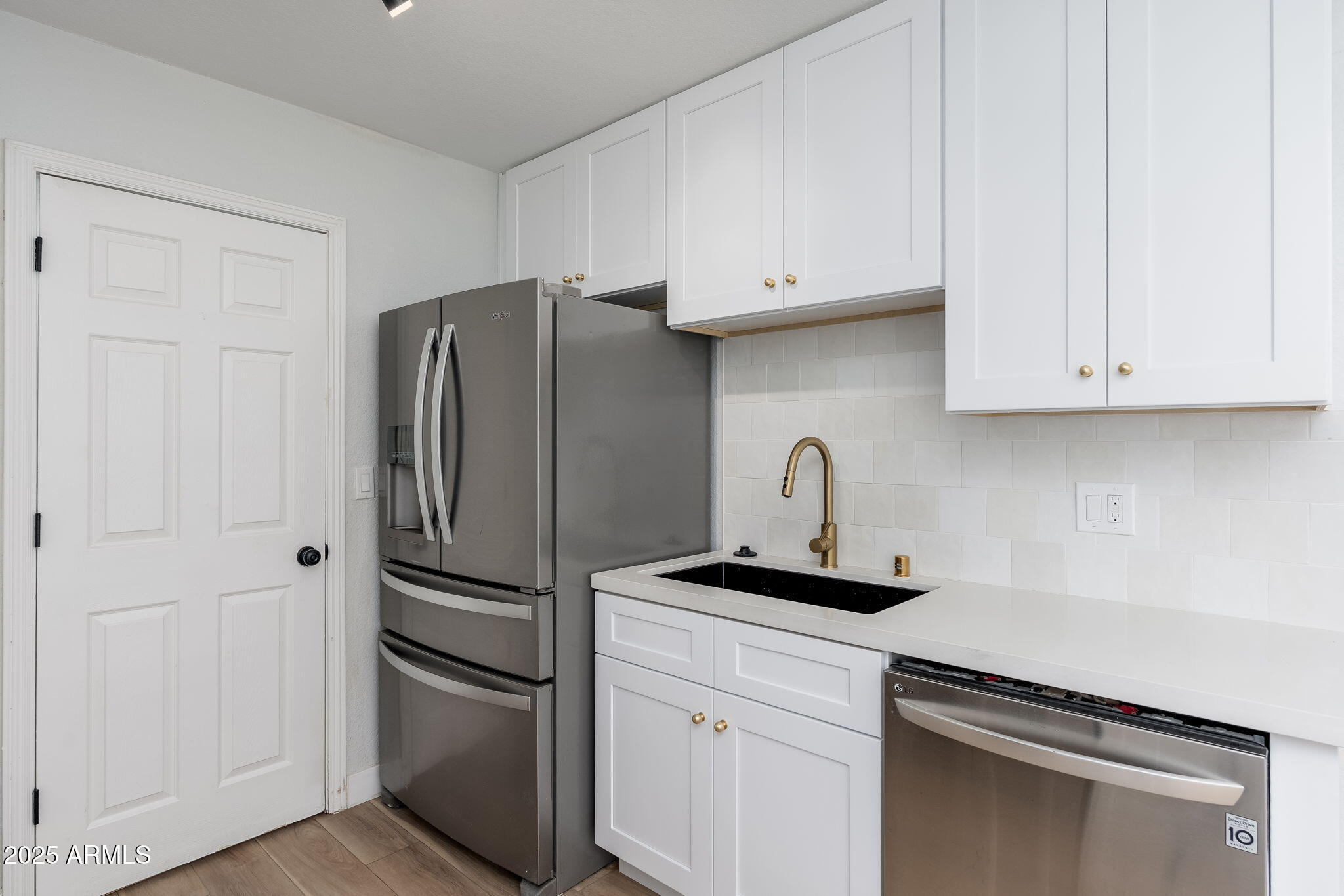 3511 East Baseline Road, Unit 1200 Phoenix, AZ 85042 - Photo 7 of 28 a kitchen with stainless steel appliances white cabinets and a refrigerator