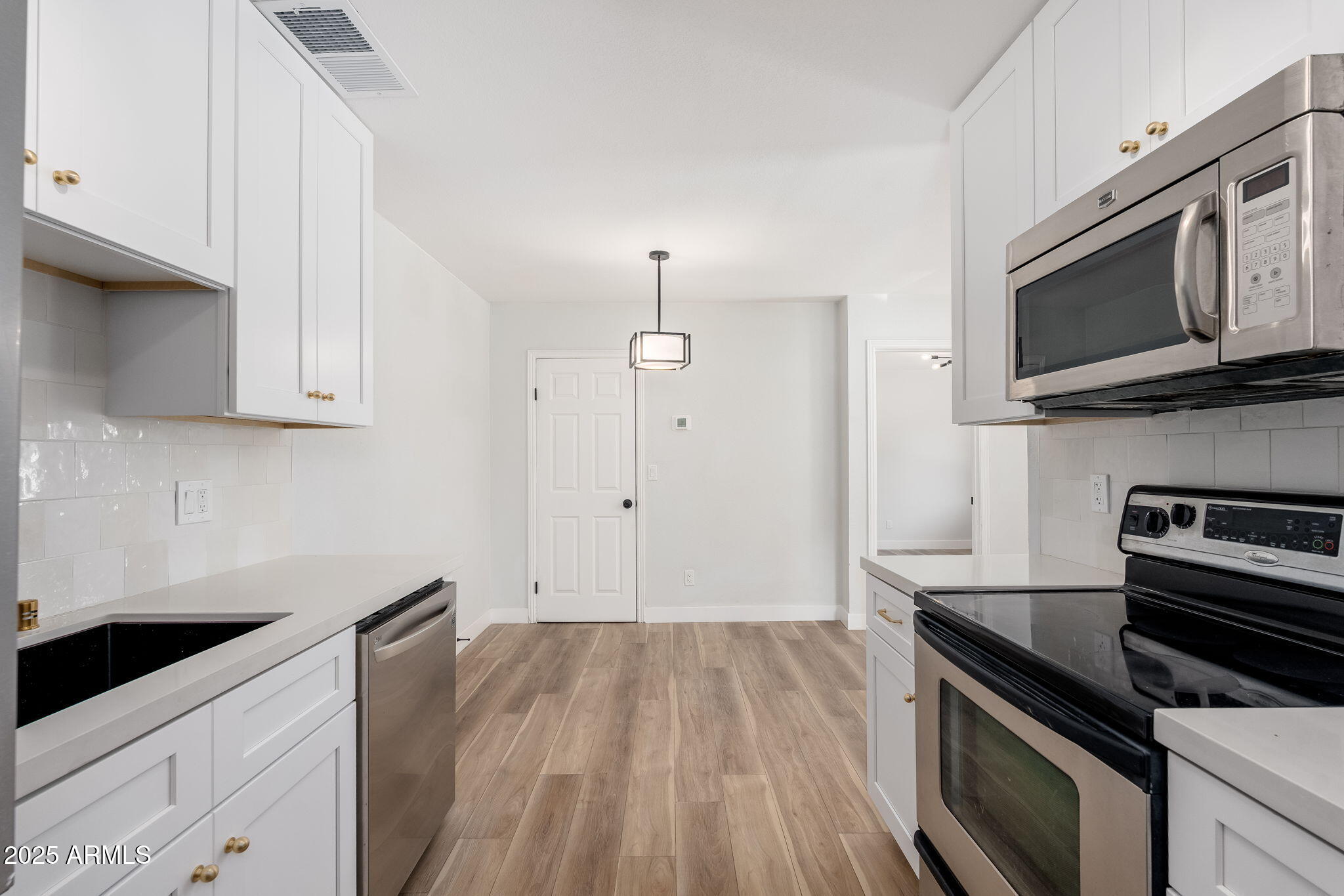 3511 East Baseline Road, Unit 1200 Phoenix, AZ 85042 - Photo 8 of 28 a kitchen with a stove microwave and sink