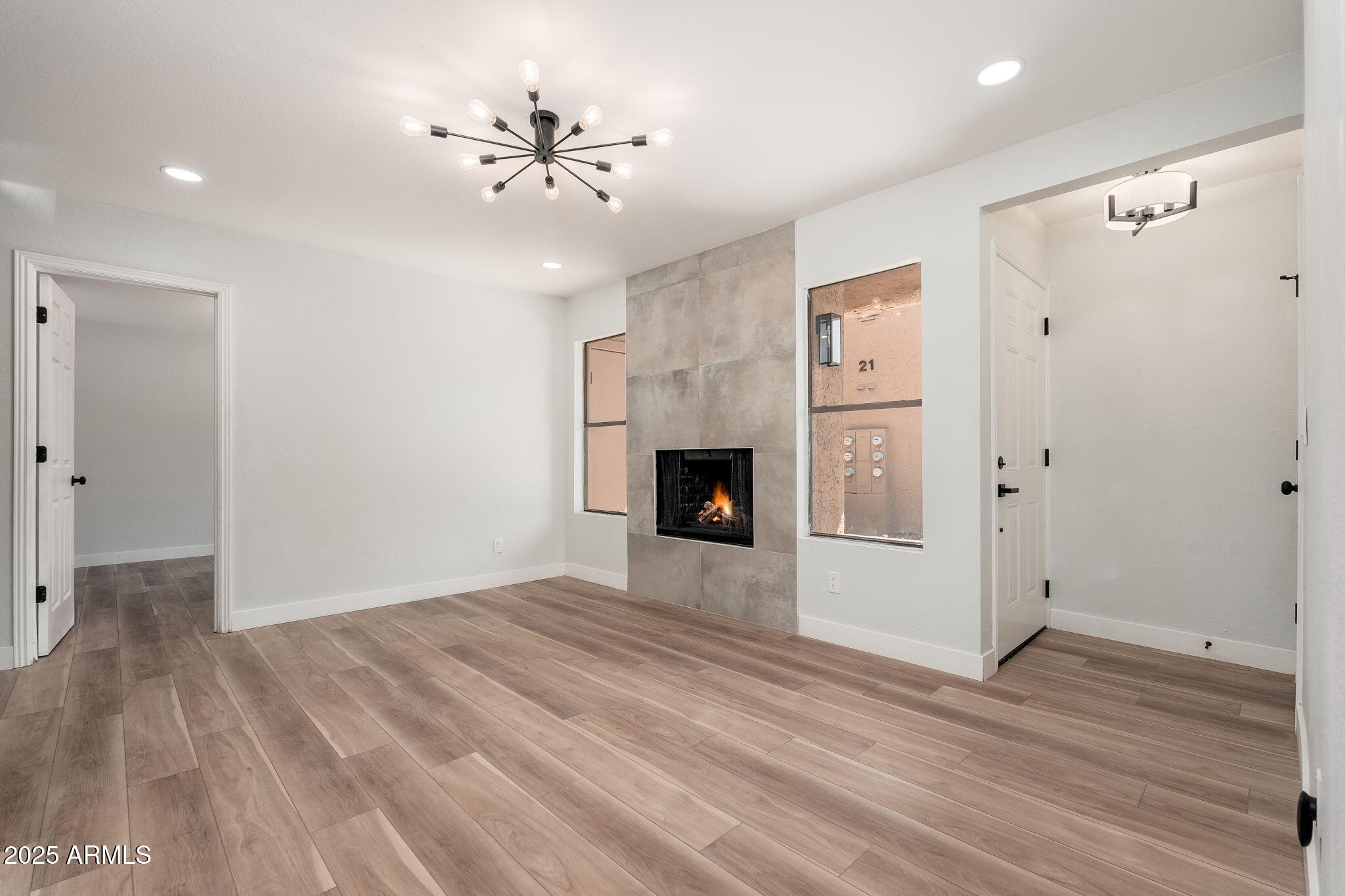 3511 East Baseline Road, Unit 1200 Phoenix, AZ 85042 - Photo 9 of 28 a view of an empty room with wooden floor and a ceiling fan