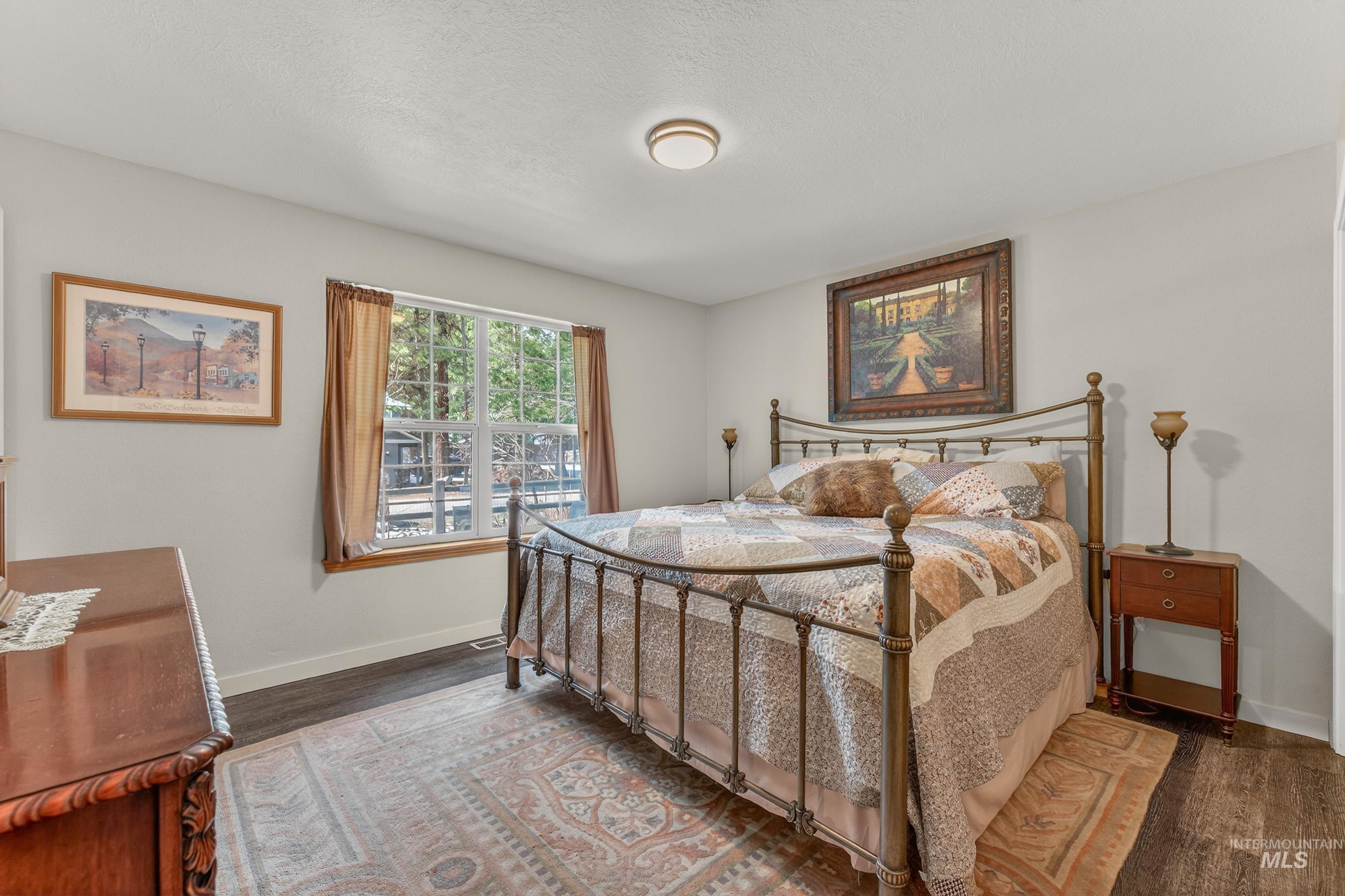 1801 Carico Road McCall, ID 83638 - Photo 12 of 30 Bedroom featuring baseboards and dark wood finished floors