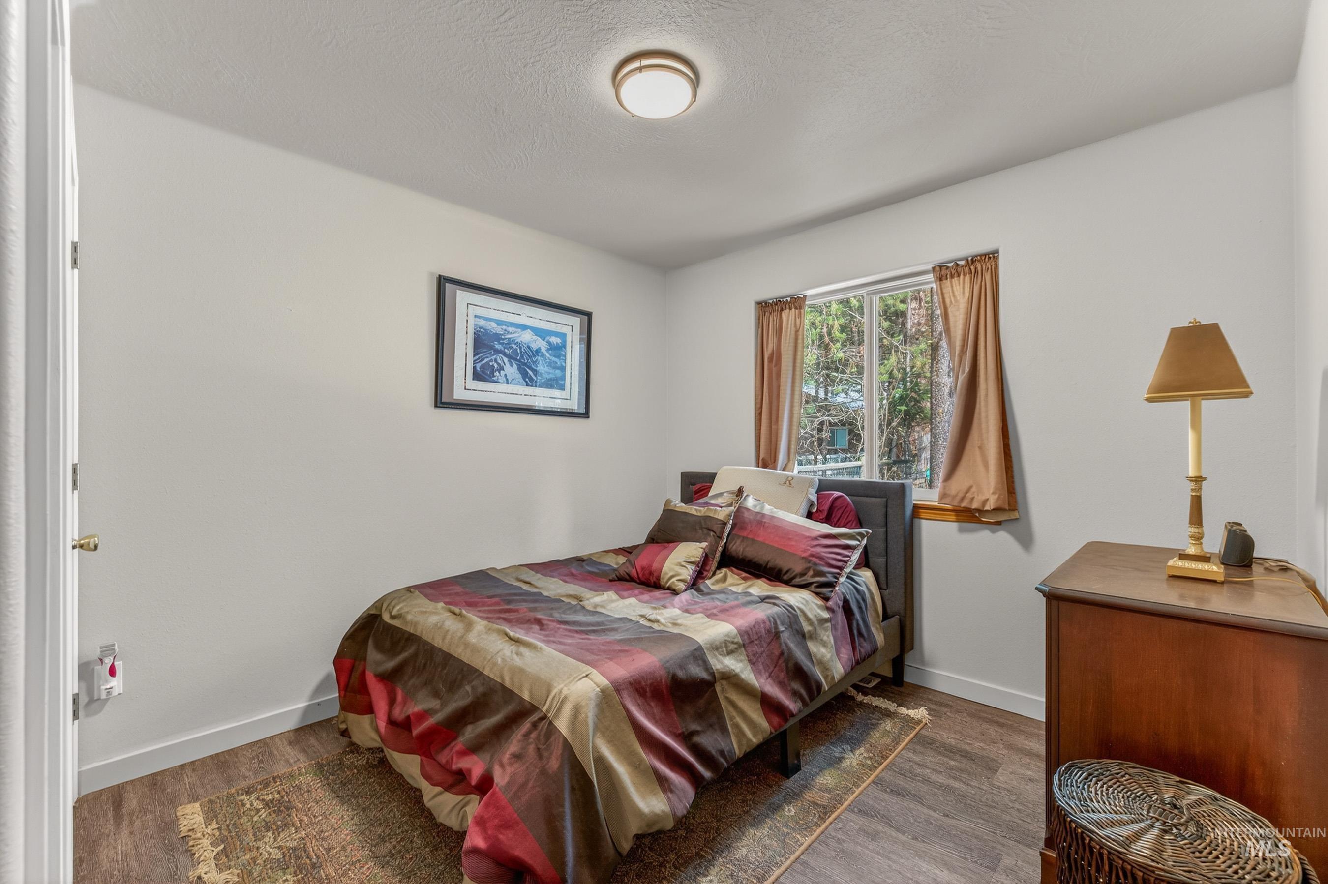 1801 Carico Road McCall, ID 83638 - Photo 17 of 30 Bedroom with dark wood finished floors and a textured ceiling