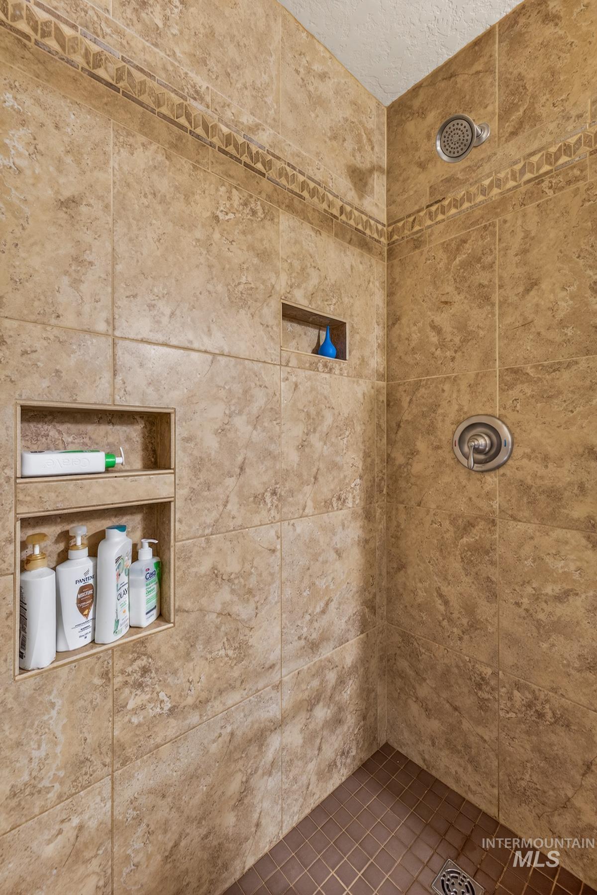 1801 Carico Road McCall, ID 83638 - Photo 20 of 30 Bathroom with a tile shower and a textured ceiling