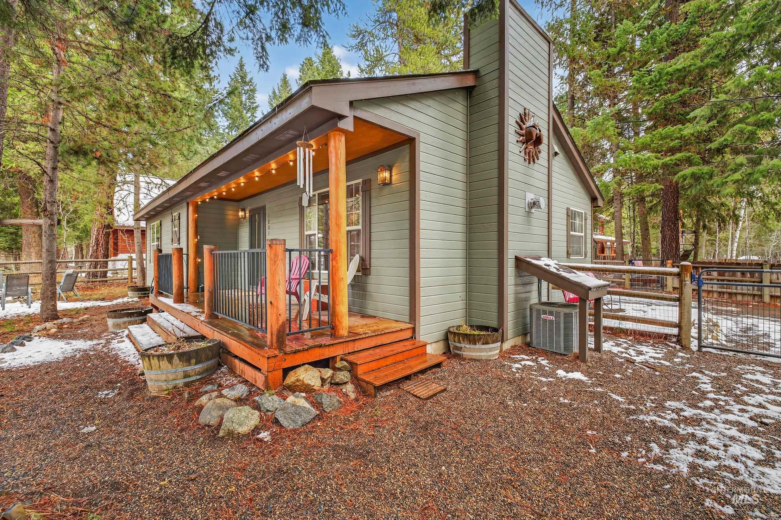 1801 Carico Road McCall, ID 83638 - Photo 28 of 30 View of home's exterior featuring a gate, a wooden deck, and a chimney