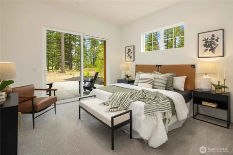 a bedroom with a bed and a couch next to a window