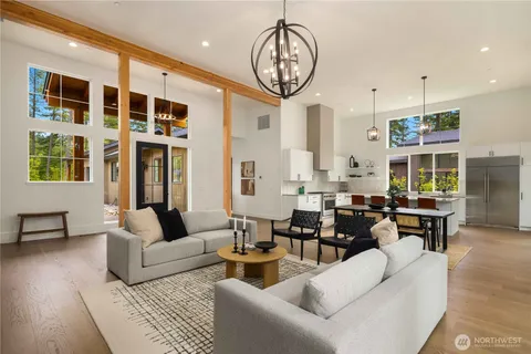 a living room with furniture a rug and white walls