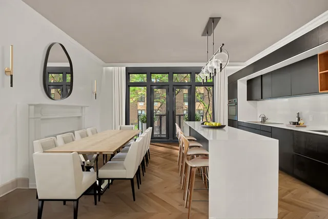 a living room with furniture a fireplace and a potted plant
