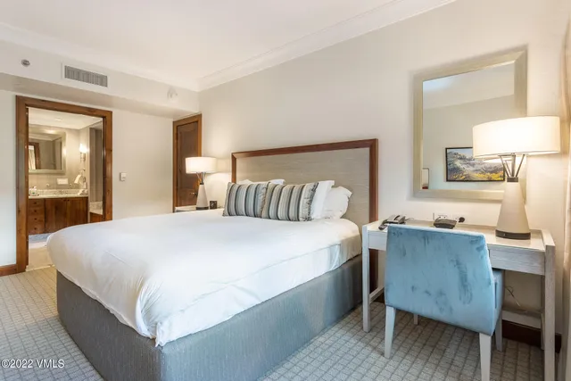 a bedroom with a bed and a table in it