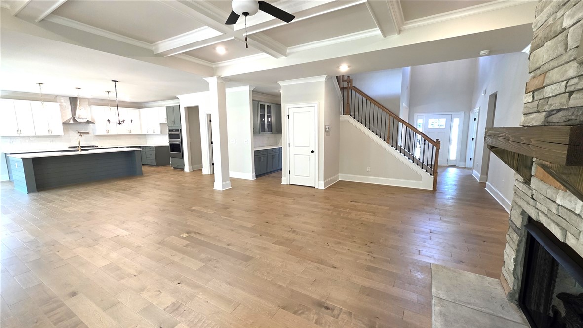 243 Holly Br Road Piedmont, SC 29673 - Photo 8 of 21 A spacious, open-concept interior featuring a grand kitchen, living area, and elegant staircase.
