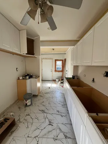 a kitchen with kitchen island a stove a sink and a refrigerator