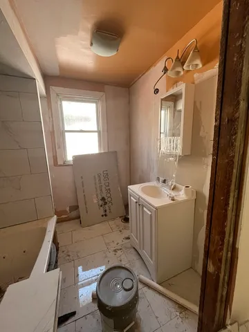 a bathroom with a sink toilet and mirror