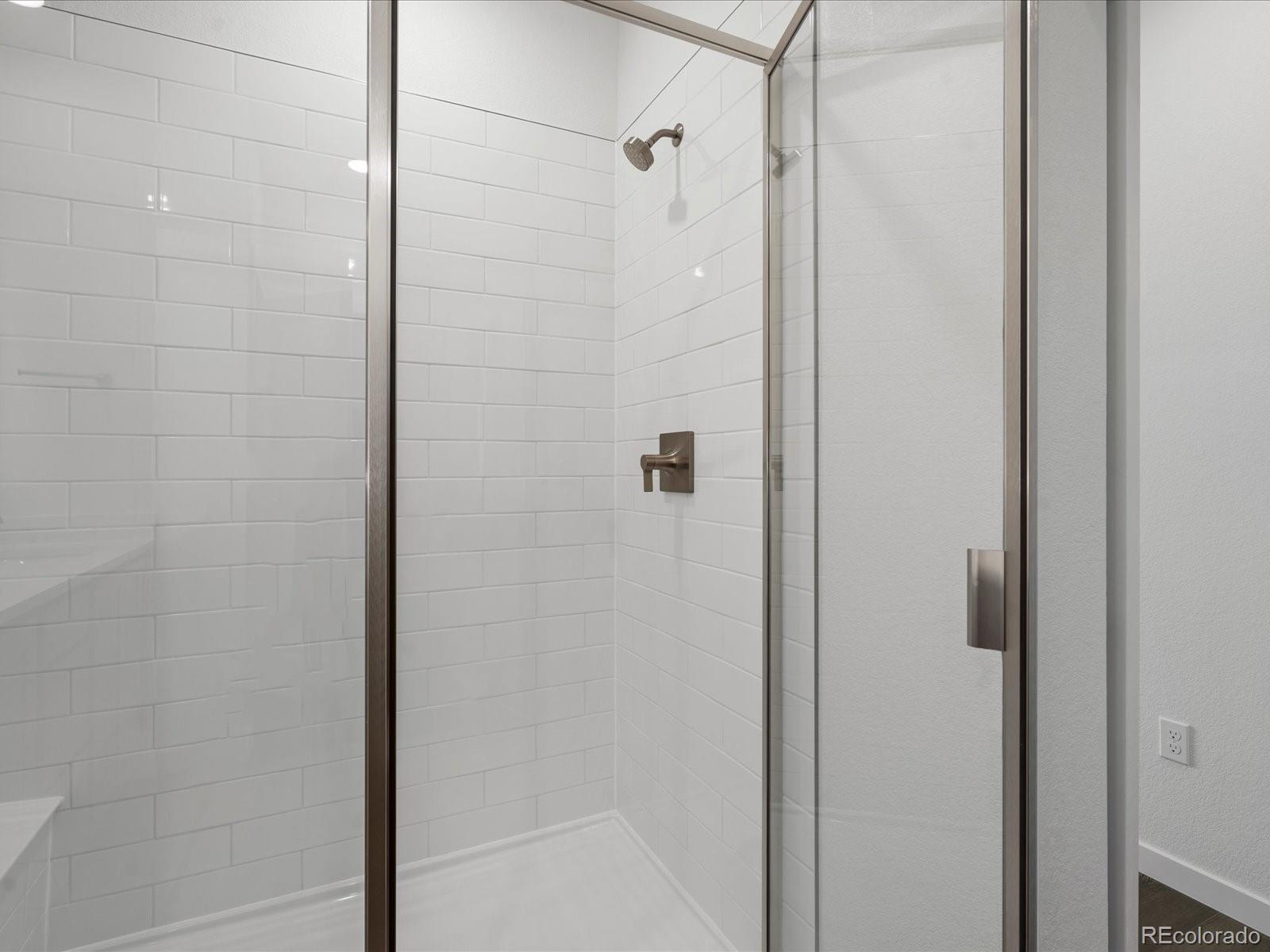 6153 North Ceylon Street, Unit 304 Denver, CO 80249 - Photo 13 of 24 a bathroom with a shower