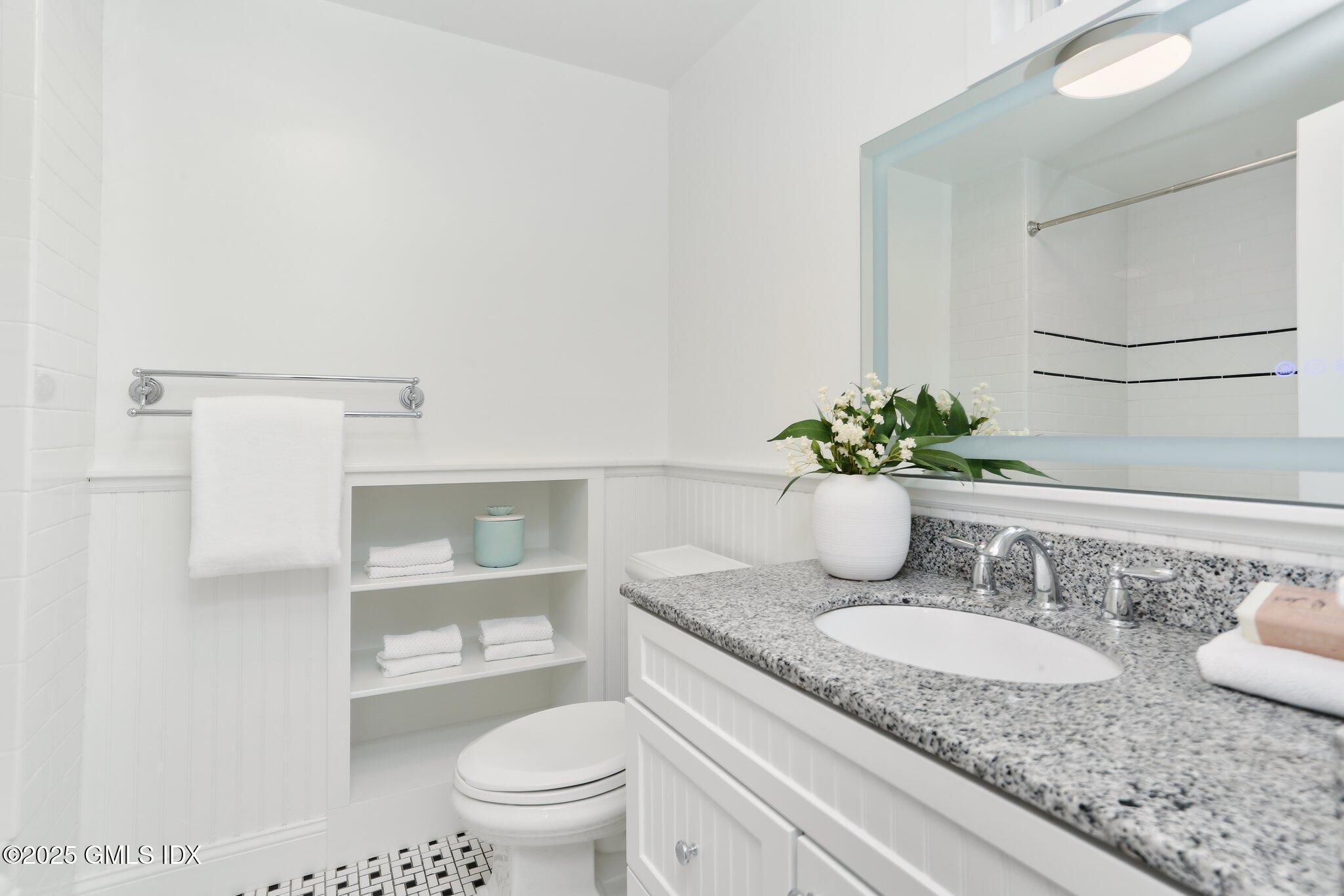 36 Hendrie Avenue Riverside, CT 06878 - Photo 17 of 33 a bathroom with a granite countertop sink a toilet and a mirror