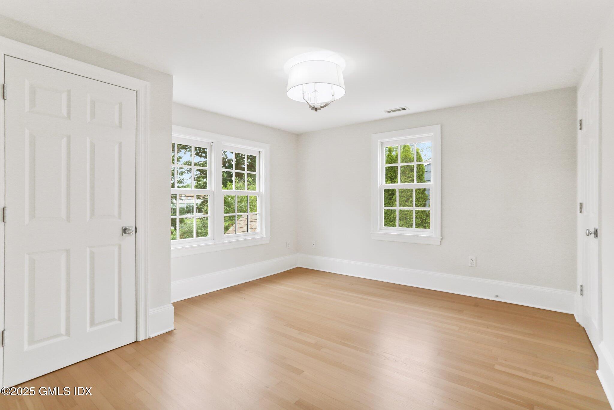 36 Hendrie Avenue Riverside, CT 06878 - Photo 18 of 33 a view of an empty room with wooden floor and a window