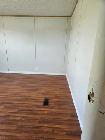 a spacious bathroom with a double vanity sink a mirror and a bathtub