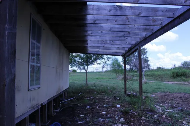 a view of a backyard with large trees