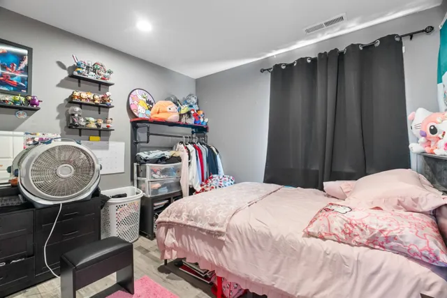 a bedroom with a bed a closet and a mirror