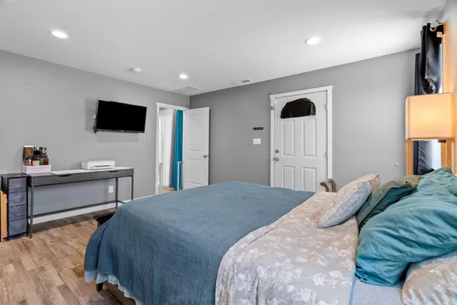 a bedroom with a bed and a flat screen tv