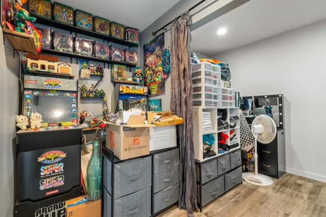 a view of walk in closet with clothes and shoes