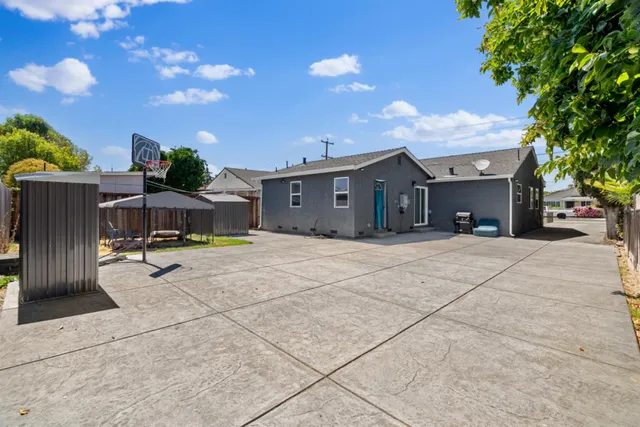 a backyard of a house with table and chairs