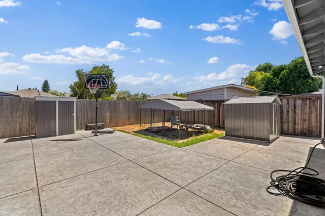 a terrace with a bench and trees