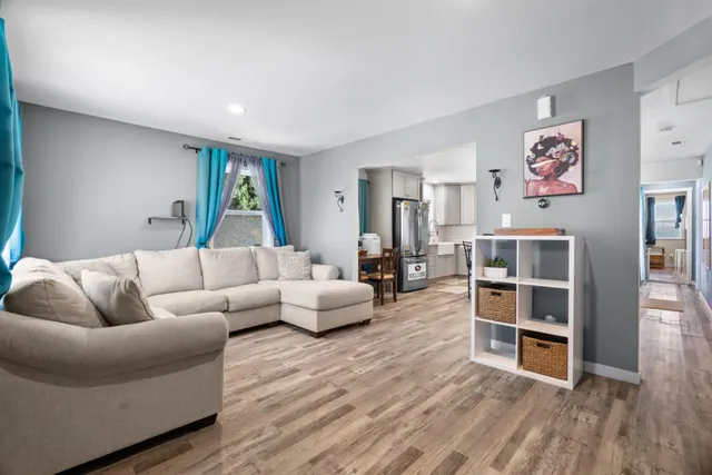 a living room with furniture and a wooden floor