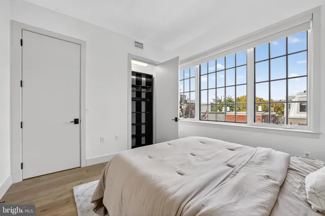 a bed sitting in a bedroom next to a window