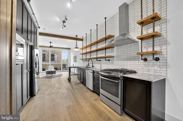 a kitchen with stainless steel appliances granite countertop a stove and a sink