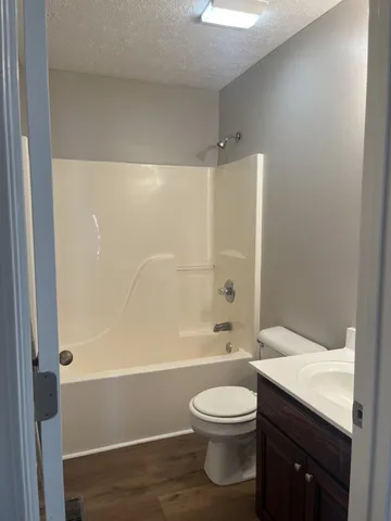 a bathroom with a toilet a sink and bathtub