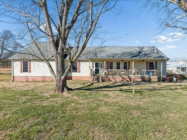 a view of a house with swimming pool and porch