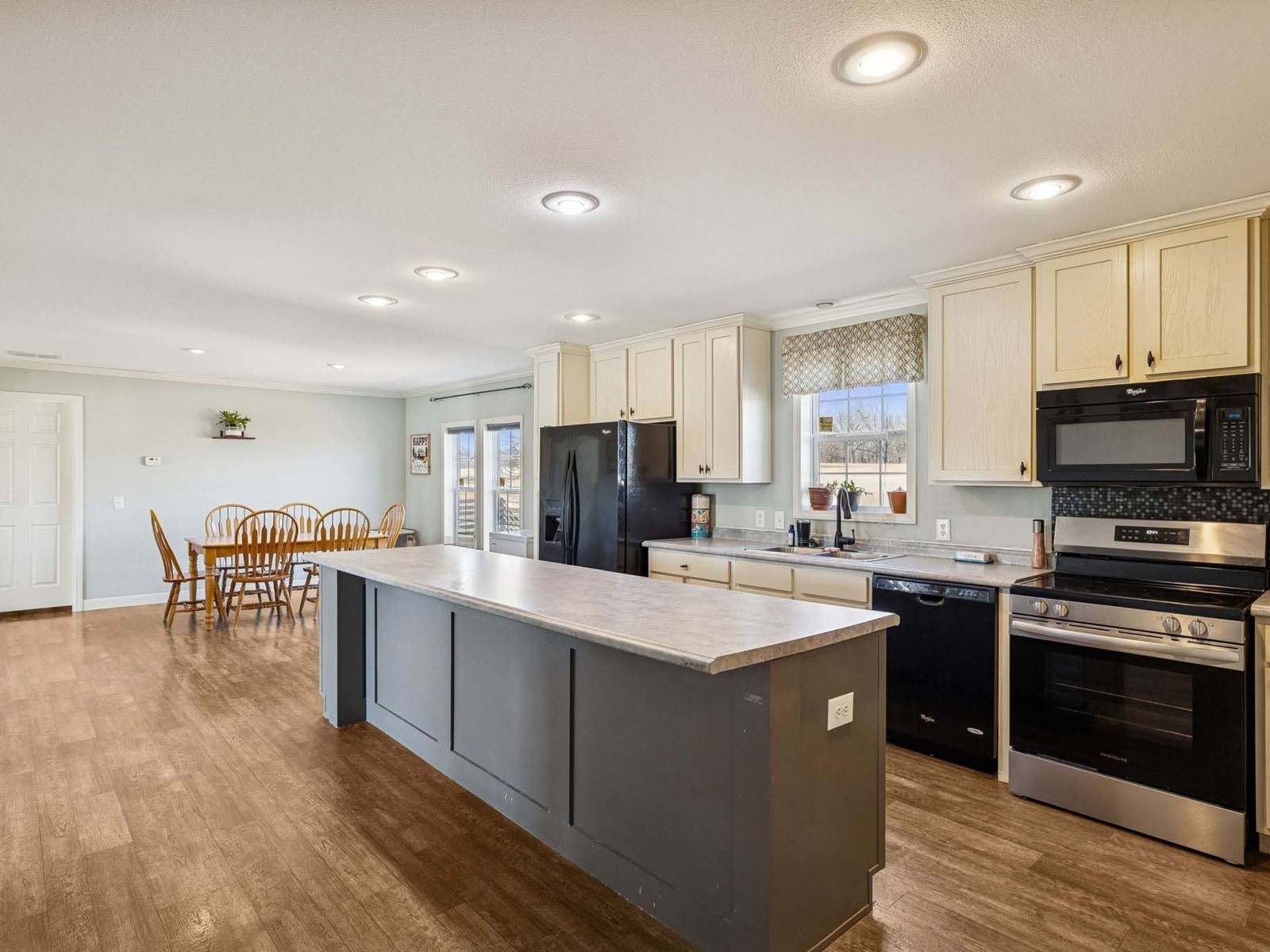 394 Pruett Road Dickson, TN 37055 - Photo 42 of 56 a kitchen with stainless steel appliances granite countertop a stove top oven a sink dishwasher and a refrigerator with wooden floor