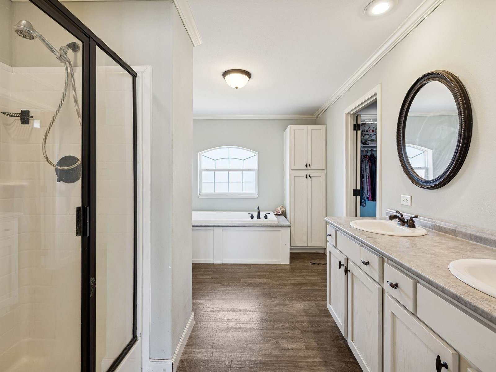394 Pruett Road Dickson, TN 37055 - Photo 47 of 56 a bathroom with a double vanity sink a mirror and a bathtub next to a window
