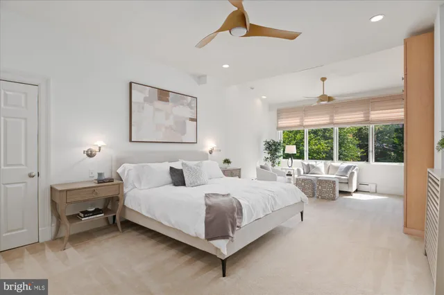 a bedroom with a bed and a large window